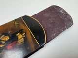 a skateboard with a picture on it sitting on a table