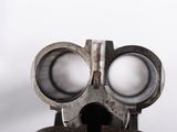 a close up of a toy gun with two big eyes