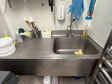 a kitchen with a sink and a metal counter