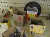 many boxes of screws on the counter in the store