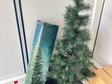 a small christmas tree sitting next to a cardboard box