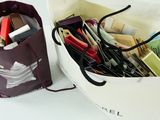 a bag with pens and pencils in it next to a bag with pens and pencils in it