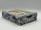 a small blue and white box with a flower design on it