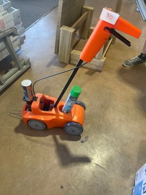 an orange toy car that is sitting on the floor