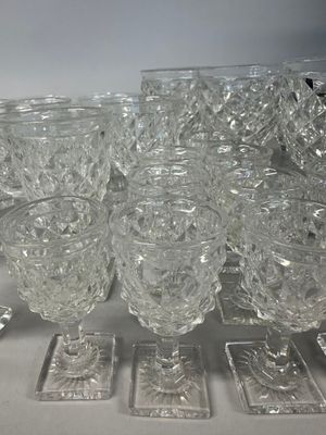 a lot of glasses that are sitting on a table