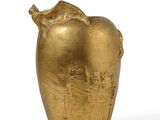 an image of a gold vase with a bird on top of it