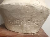 a stone vase sitting on top of a wooden block