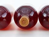 three bottles of wine sitting on a white surface
