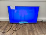 an image of a flat screen tv sitting on top of a wooden floor