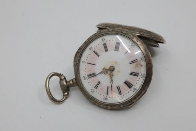 a silver pocket watch with roman numerals on it