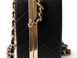 a black and gold purse with a chain around it