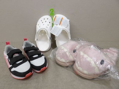 two pairs of shoes and a stuffed animal on the floor