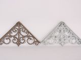 a pair of decorative metal brackets on a white background