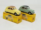 deux petites voitures miniatures posées sur une boîte