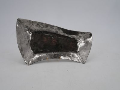 a close up of a metal object on a white surface