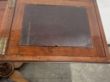 a small wooden table with a glass top on it