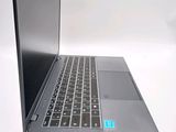 a laptop that is open on a white surface