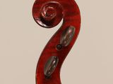 a close up of the back of a violin with a fiddle in the foreground