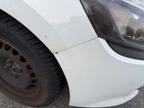 a close up of a white car with a flat tire