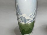 two vases sitting side by side on a white surface