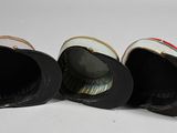 three hats sitting on top of each other on a white surface