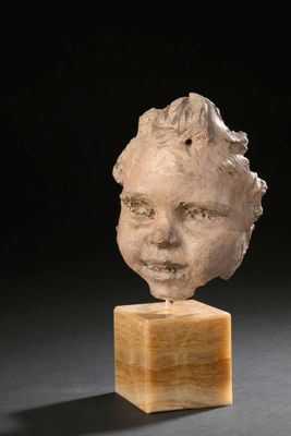 marble head of a child on a wooden block