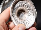 a person holding a silver object in their hand