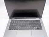 an open laptop computer sitting on top of a white table