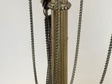 an image of a lamp with chains on the base of it