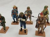 six figurines of soldiers with rifles and helmets on wooden bases