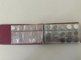 a red case with a bunch of coins in it