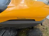 a close up of a yellow lawn mower parked on the side of the road