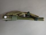 a small toy gun with a glove on top of it
