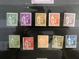 several different colored stamps are on display in a glass case