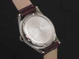 an image of a close up of a watch on a black background