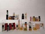 many different types of perfumes on display on a shelf