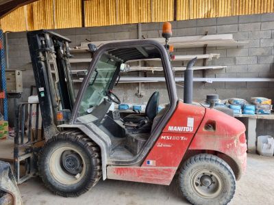 a red forklift truck parked in a garage