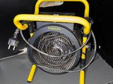 a yellow fan sitting on top of a metal cabinet
