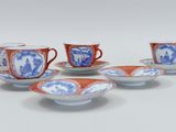 four cups and saucers with blue and white designs on them