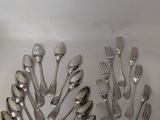 a lot of spoons and forks on the table