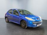 the small blue car is parked in a room with a black floor