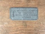 a wooden box with a metal plate on it