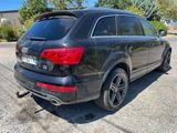 the rear end of a black audi suv parked in a parking lot