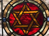 a stained glass window with a star of david on it