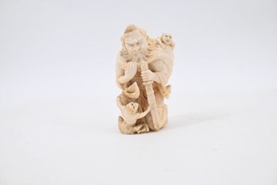 carved ivory figurine of a man with a basket of flowers