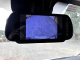a rear view mirror with a picture of a person in it