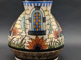 a vase with a colorful design on it on a table