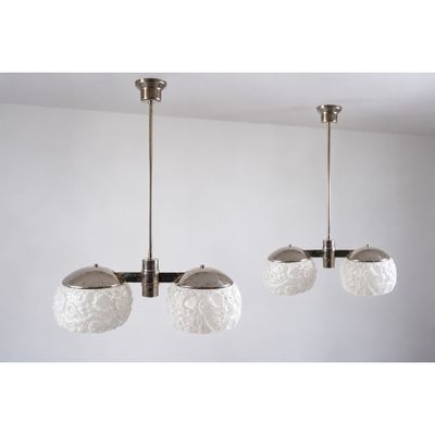 the three lights are hanging from the ceiling in the room