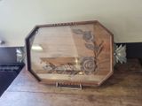 a wooden tray with a picture on it sitting on a counter