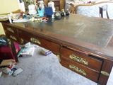 a desk that has a lot of clutter on top of it